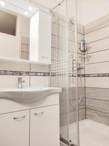 a bathroom with a sink and a shower at Apartments by the sea Sevid, Trogir - 9468 in Sevid