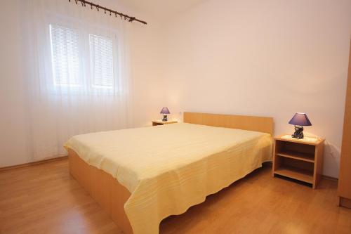 sypialnia z łóżkiem i 2 szafkami nocnymi z lampkami w obiekcie Apartment Zubovici 9365d w mieście Zubovići