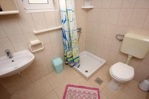 a small bathroom with a toilet and a sink at Studio Zubovici 9365a in Zubovići