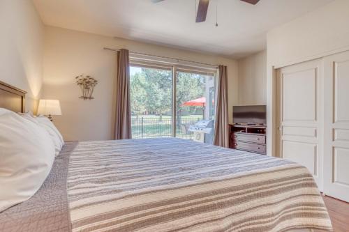 a bedroom with a bed and a large window at Aspen Retreat - Meredith Lodging in Redmond