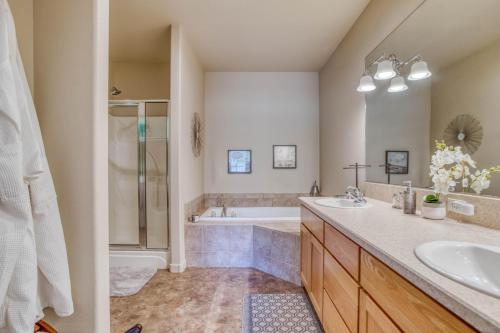 a bathroom with a tub and a sink and a shower at Aspen Retreat - Meredith Lodging in Redmond