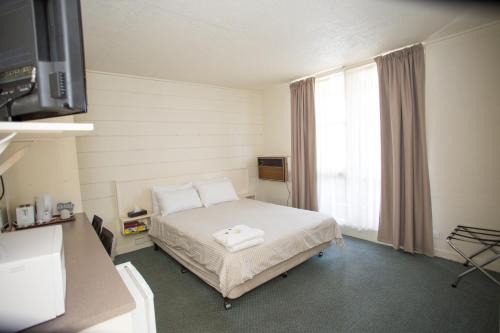 a hospital room with a bed and a window at Corio Bay Motel in Corio
