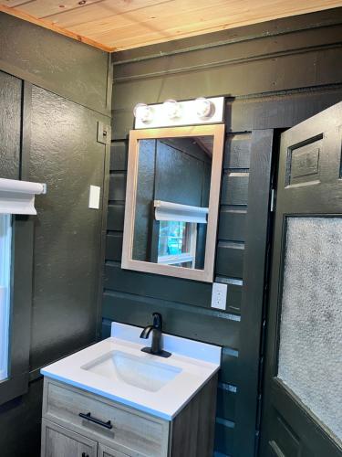 a bathroom with a sink and a mirror at Camp Hudson Pines in Corinth