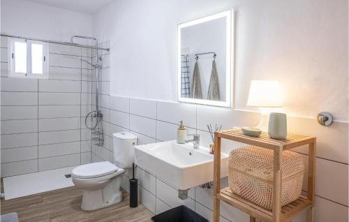 a bathroom with a sink and a toilet and a mirror at Nice Home In La Isla De La Palma c With Outdoor Swimming Pool in Los Llanos de Aridane