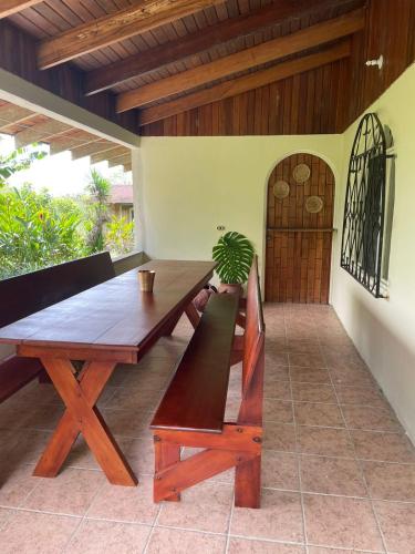 a wooden table and bench on a patio at Casa de Campo La Guaria in Guaria