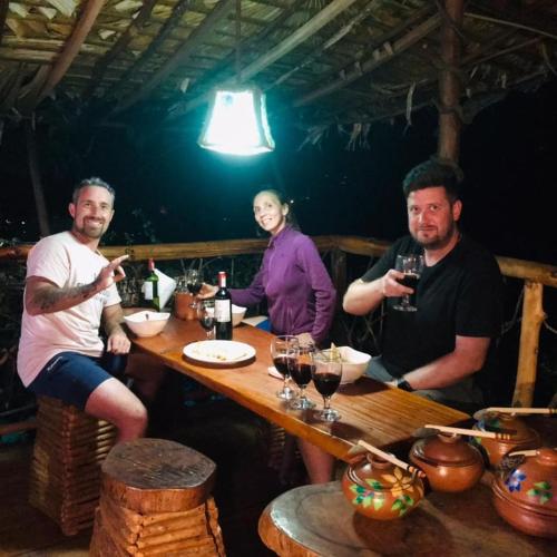 a group of people sitting at a table with wine glasses at Dream Ville in Ella