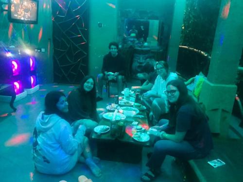 a group of people sitting around a table in a room at Dream Ville in Ella