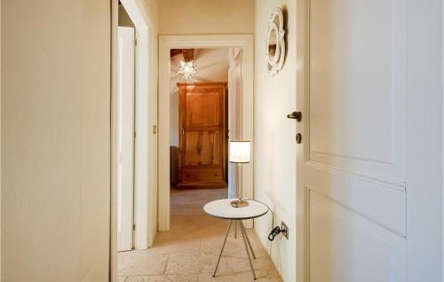 a hallway with a table and a door and a stool at Beautiful Home In Loc, Spicciano With Outdoor Swimming Pool in Terenzano