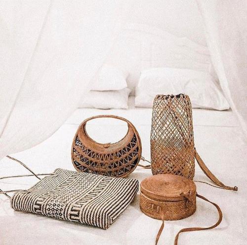 two baskets and a bag on a bed at Sal Secret Spot in Uluwatu