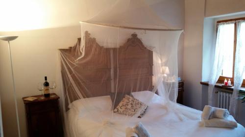 a bedroom with a canopy bed with two pillows on it at Agriturismo La Camporena in Greve in Chianti