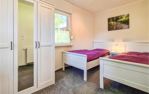 a bedroom with two beds and a window at Nice Home In Harzgerode Ot D, With Wifi in Dankerode