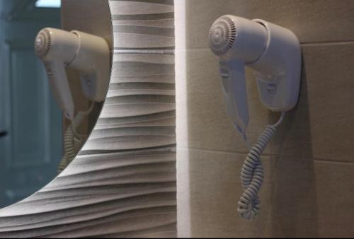 a couple of hair dryers hanging on a wall at Family Studios in Marathias