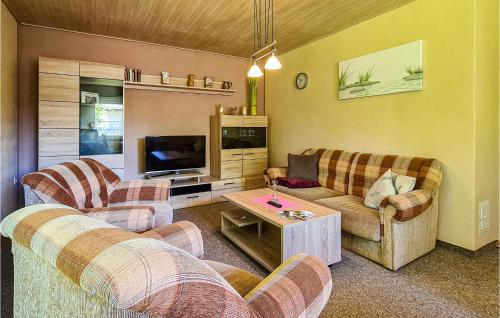 a living room with two couches and a tv at 1 Bedroom Nice Home In Harzgerode Ot D in Dankerode