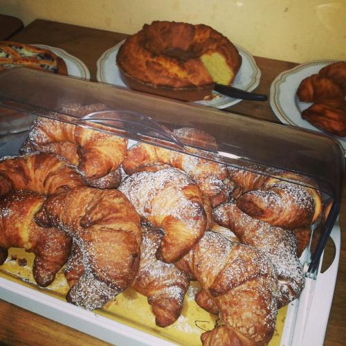 a display case with croissants and other pastries and bread at Osteria Della Posta in Poggio Picenze