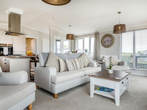 a living room with a couch and a table at Number 8 Lakes View in Burnham on Sea
