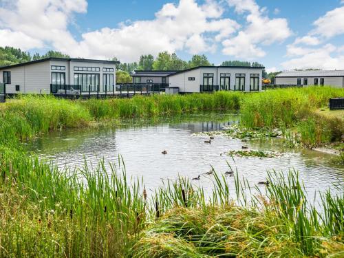 a pond in front of buildings with ducks in it at Number 8 Lakes View in Burnham on Sea