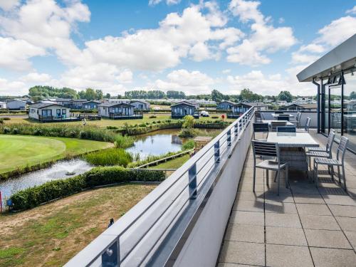 a balcony with a table and chairs and a river at Number 8 Lakes View in Burnham on Sea