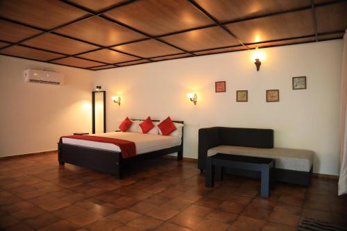 - une chambre avec un lit et une chaise dans l'établissement Lakefront Beach Homes, à Cherai Beach