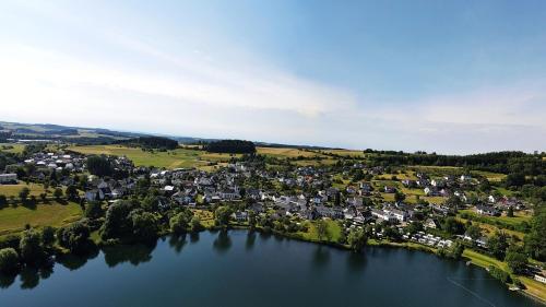 an aerial view of a small town on a lake at Luxus Ferienwohnung Chalet Seenähe in Schalkenmehren
