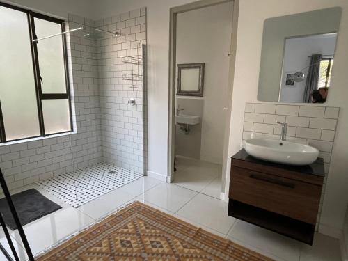a bathroom with a sink and a shower at PepperTree Guest House in Johannesburg