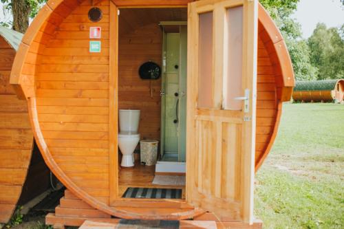 an outside door of a toilet in a wooden house at Ezermala in Valdemārpils