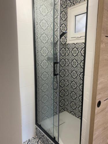 a shower with a glass door in a bathroom at Nice port : cosy appartement au calme in Nice