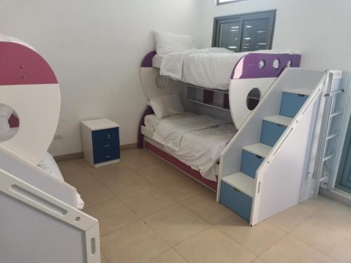 a small room with a bunk bed and a bunk bed at Talabay AQABA in Aqaba