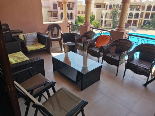 a balcony with chairs and a table and a couch at Talabay AQABA in Aqaba