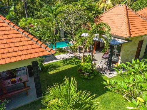 an aerial view of a house with a garden at Coco Garden Pool Villas in Kubutambahan
