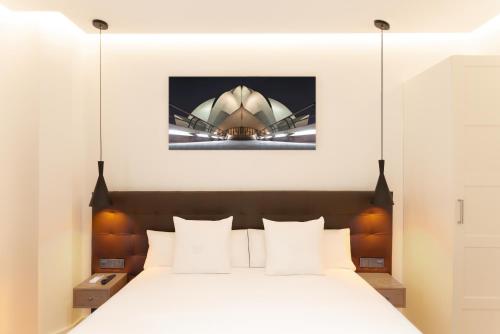 a bedroom with a bed and the sydney opera house at Woohoo Rooms Boutique Gran Vía in Madrid