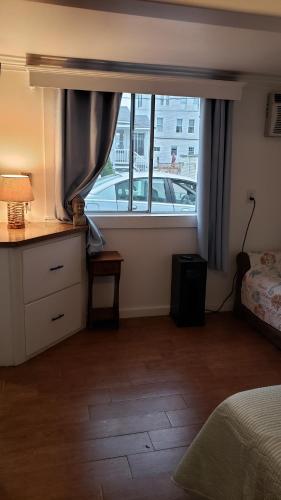 a bedroom with a large window with a bed and a desk at White Cap Village Unit 6 in Old Orchard Beach