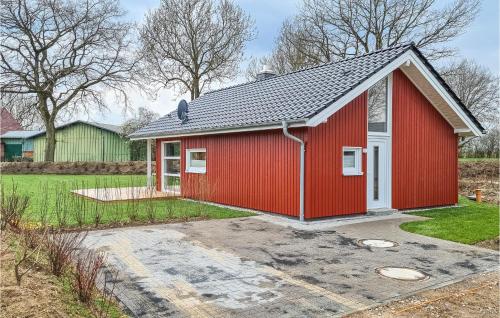 a red house with a gray roof at Cozy Home In Krems Iiwarderbrück in Göls
