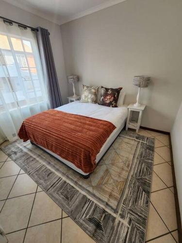 a bedroom with a bed with a large window at 56 - Elegant 2 bed apartment next to Gautrain Centurion in Centurion
