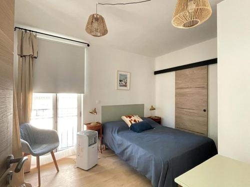 une chambre avec un lit, une chaise et une fenêtre dans l'établissement Avignon pedestrian area, charming, 4 persons, à Avignon