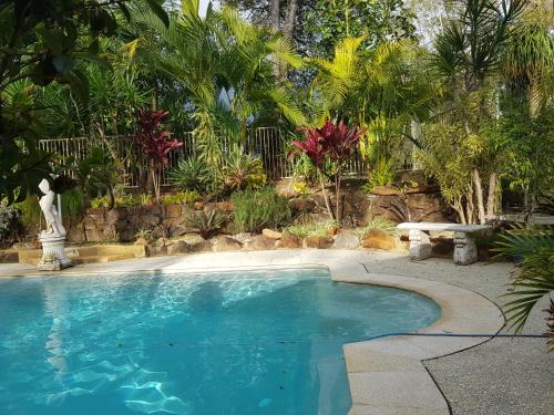 a large swimming pool in a yard with trees at Mapleton Peaceful Provence BnB in Mapleton