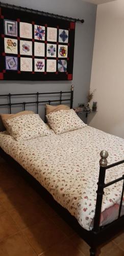 a bed with a blanket and pillows in a bedroom at Apartamento en Vall d'Incles in Incles