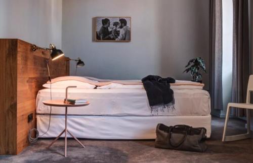 a bedroom with a large bed and a table at Hotel city.city in Ostrava