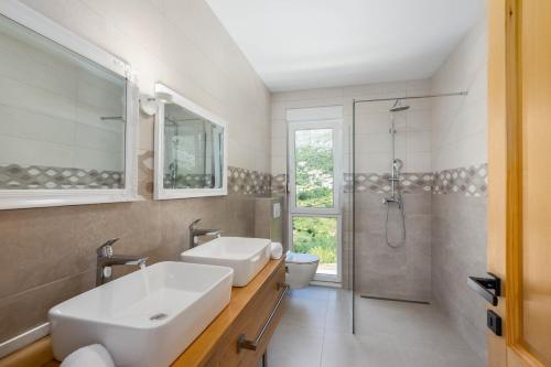 a bathroom with a sink and a shower at Villa Dorso with heated pool in Klis