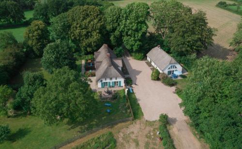 an overhead view of a large house in the countryside at Moorhuus - Paradies am Wilden Moor in Winnert