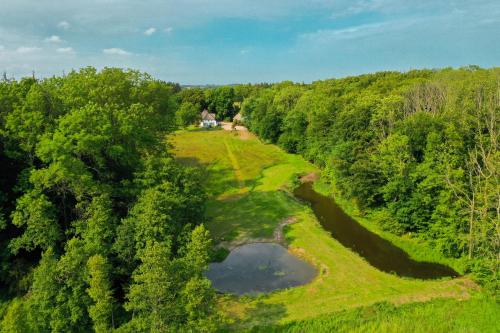 an aerial view of a golf course with a pond at Moorhuus - Paradies am Wilden Moor in Winnert