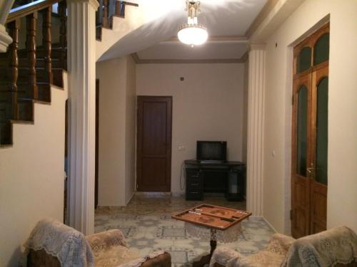 a living room with a couch and a table at Talo's Guest House in Makhinjauri