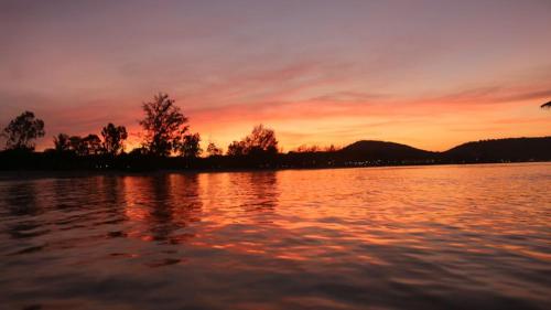 a sunset over a large body of water at Mangrove Beach Bungalows in Koh Rong Sanloem