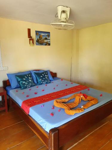a bed in a room with two blankets on it at Mangrove Beach Bungalows in Koh Rong Sanloem