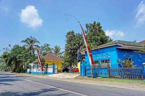 a blue building on the side of a street at OYO 91573 Hotel Family Blitar in Blitar