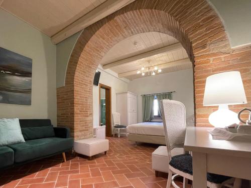 a living room with a couch and a bed at Ca' Virginia Country House Wellness in Montecalvo in Foglia