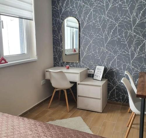 a bedroom with a vanity and a mirror and a desk at Apartman Skyline Kopaonik in Kopaonik