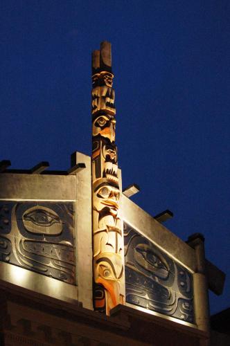 a building with a clock tower at night at Skwachàys Lodge in Vancouver