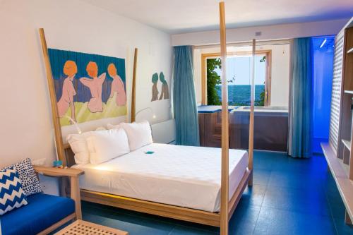 a bedroom with a bed and a view of the ocean at Approdo Resort Thalasso Spa in Castellabate