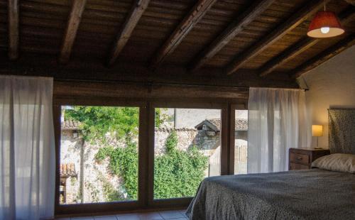 a bedroom with a bed and a large window at Country Home Lonato in Lonato del Garda
