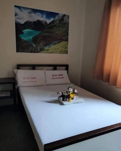 Ένα ή περισσότερα κρεβάτια σε δωμάτιο στο WJV INN CASUNTINGAN